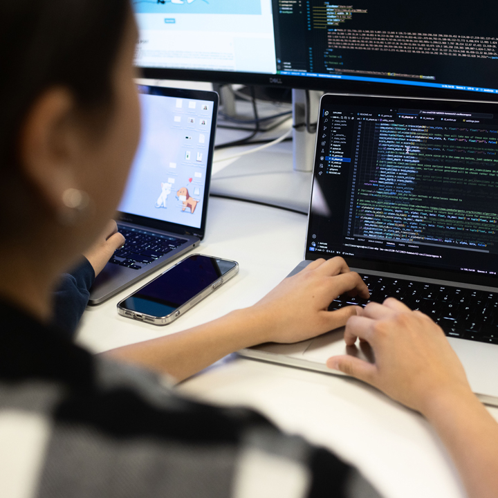 Student Working on a Laptop with Data on the Screen