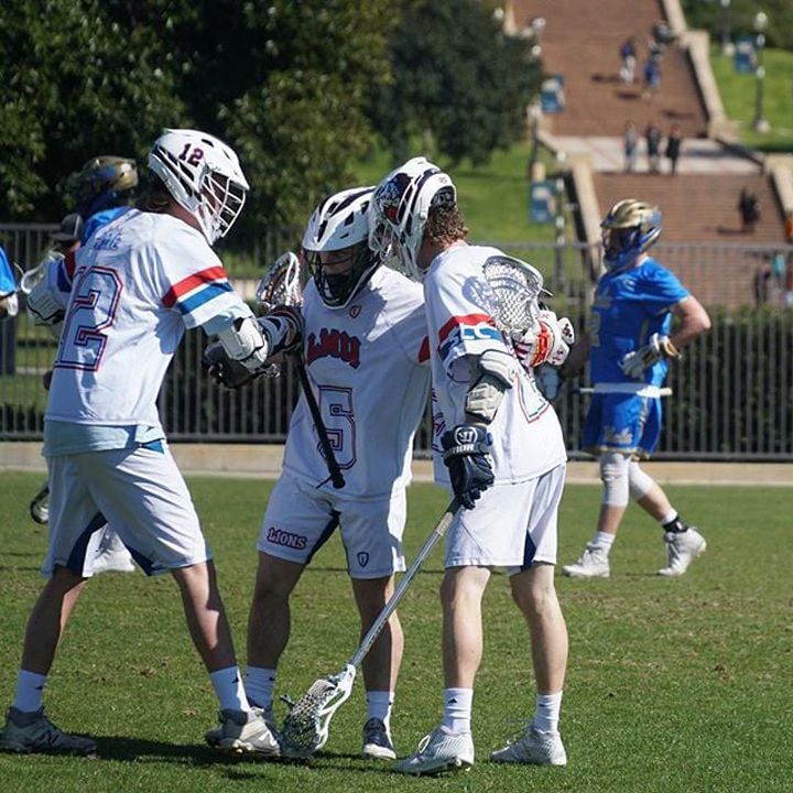 LMU lacrosse players huddle