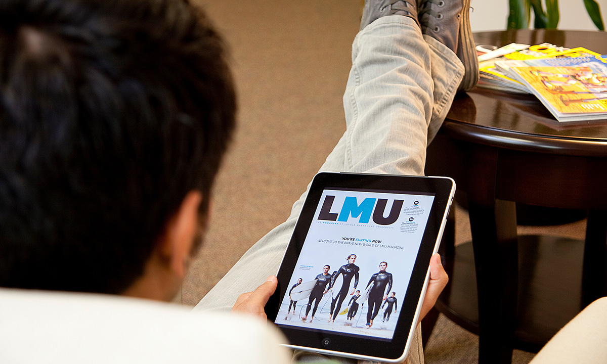 A student looking at the LMU Magazine website on a tablet