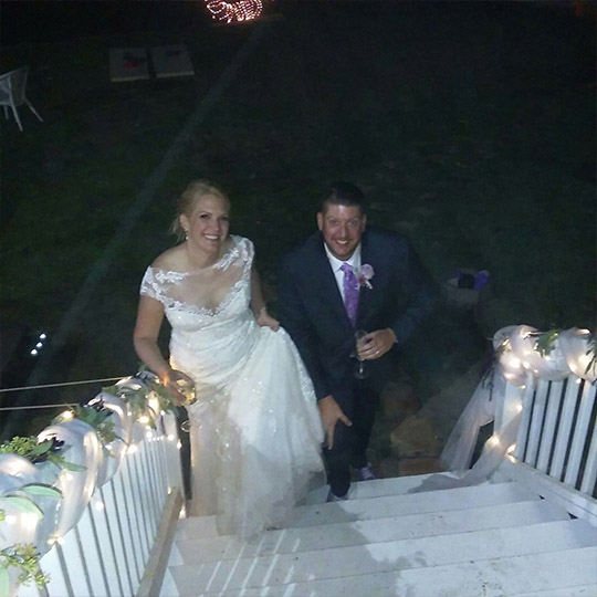 Couple in wedding dress and suit on stairs