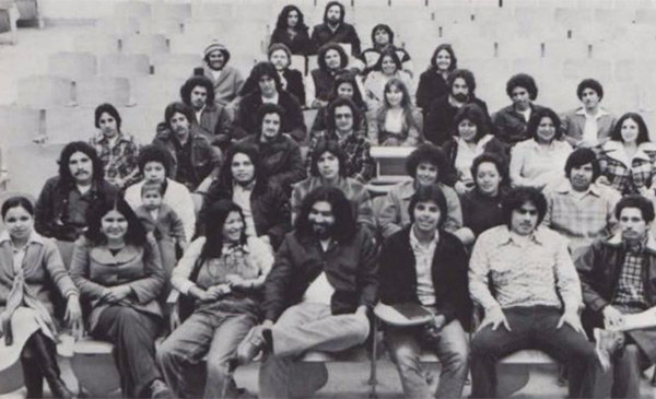A black and white photo of MeCHA alumni sitting in an auditorium